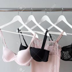 Pink bra hanging on a hanger. Textile, Underwear. Female bra in lingerie underwear store. Advertise, sale, fashion concept